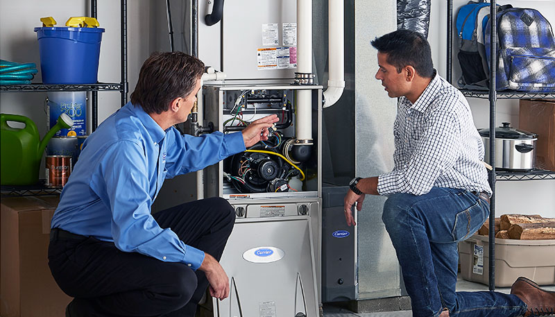 HVAC technician evaluating a furnace for repair or replacement in Salt Lake City