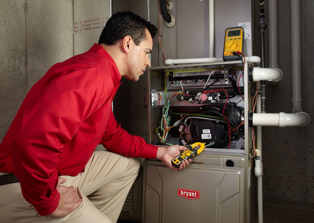 HVAC technician repairing an indoor furnace in Salt Lake City