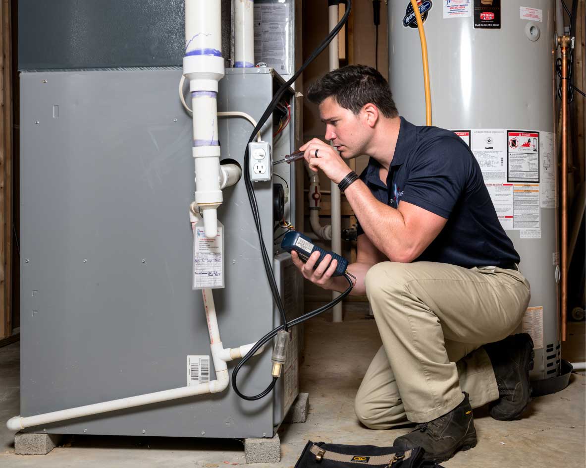 HVAC technician performing a furnace tune-up in Salt Lake City