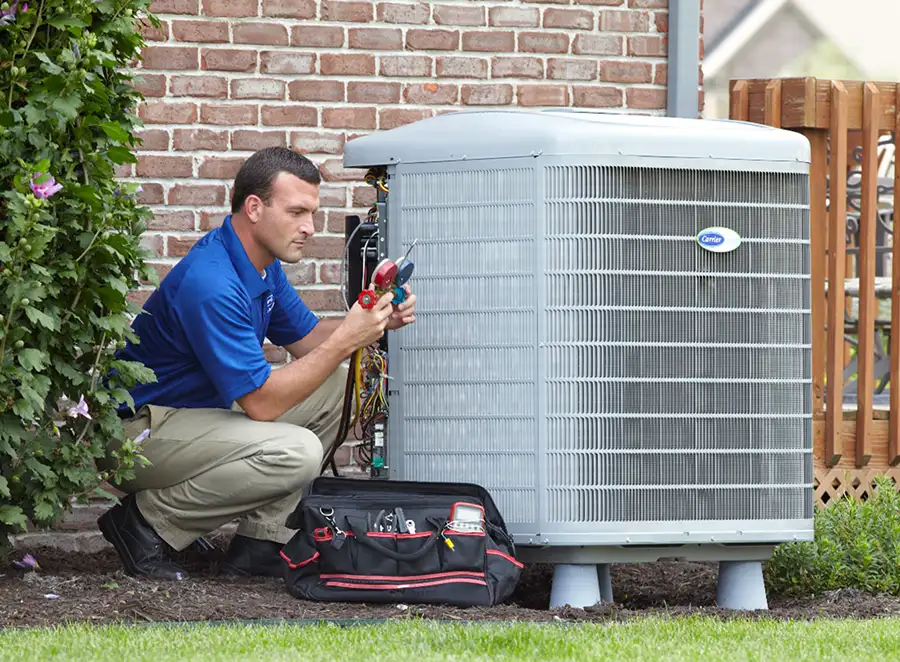 HVAC technician inspecting an outdoor air conditioning unit in Salt Lake City