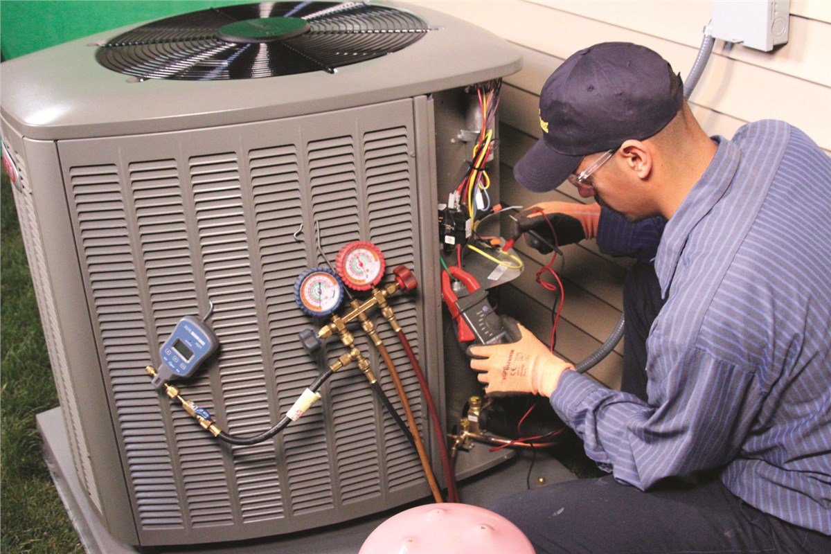 HVAC technician testing an outdoor air conditioning unit in Salt Lake City