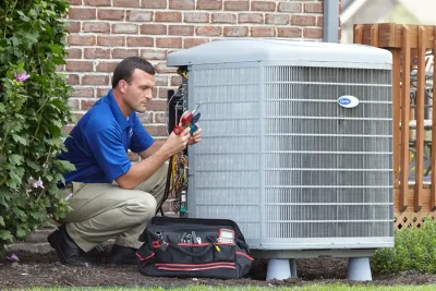 HVAC technician inspecting an outdoor air conditioning unit in Salt Lake City, UT